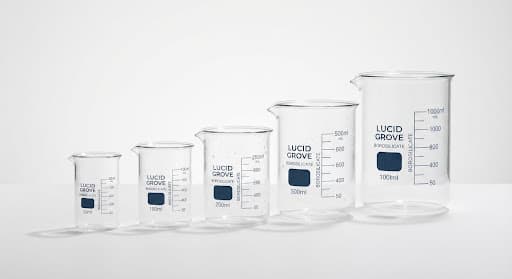 A set of borosilicate glass beakers lit crisply against a stark white background.