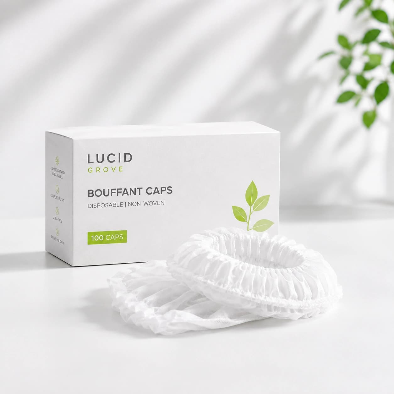 A Lucid Grove box of disposable bouffant caps with a cap laid out beside it.