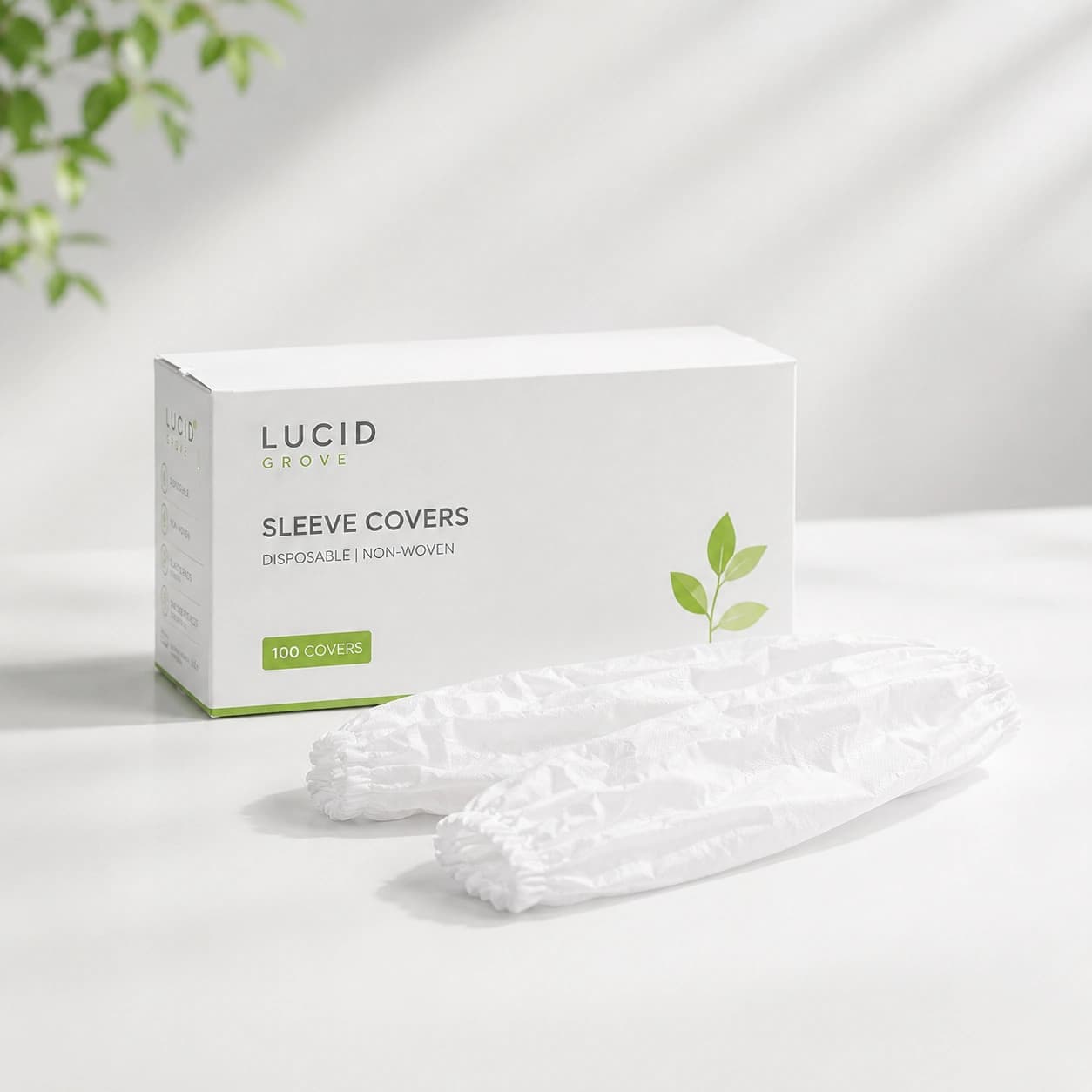 A Lucid Grove box of disposable sleeve covers with a pair laid out beside it.