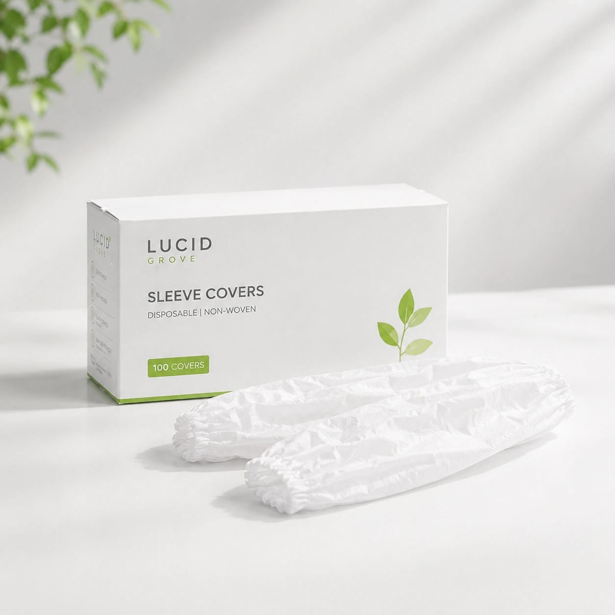 A Lucid Grove box of disposable sleeve covers with a pair laid out beside it.