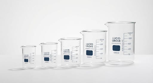 A set of borosilicate glass beakers lit crisply against a stark white background.